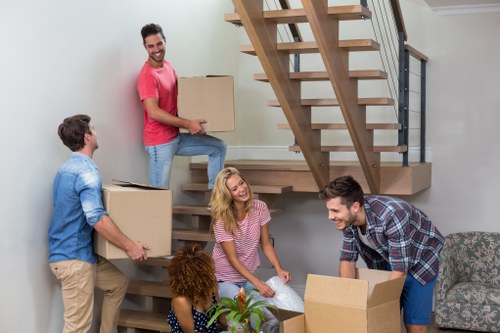 Local movers loading furniture into a van near a Haringey flat