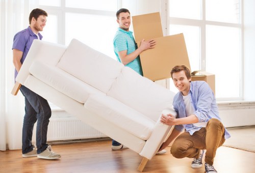 Removal team loading furniture for a home or office move in Haringey
