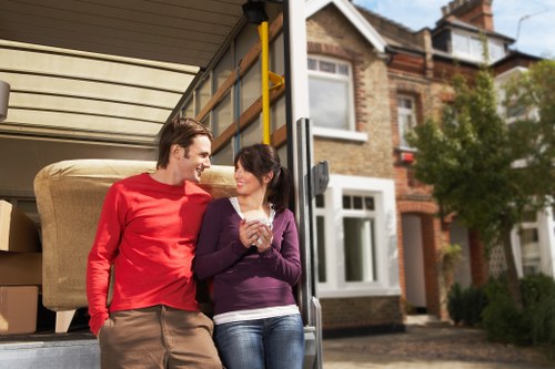 Professional movers loading household items into a removal van